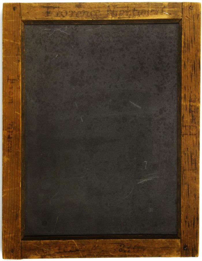 Writing slate in an inscribed, wooden frame. Given to Florence Nightingale by her mother on 11th October, 1830.